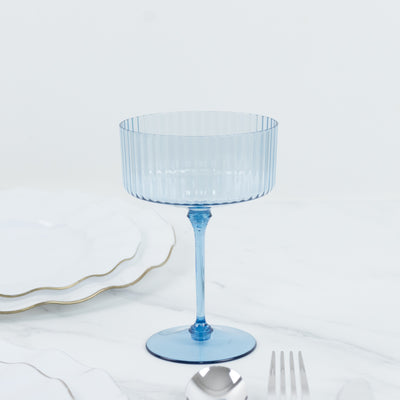 Blue ribbed glass dessert cup on a white background.