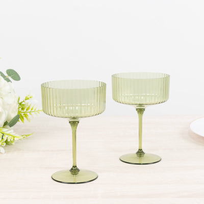 Two green ribbed glass goblets on stems, modern elegant drinkware set
