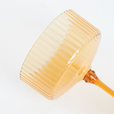 Amber ribbed glass dessert cup on white background