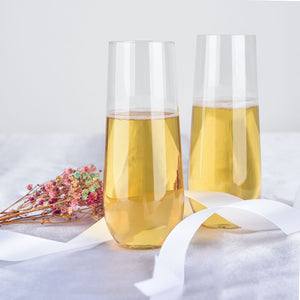 Elegant champagne flutes with golden liquid and floral accents.