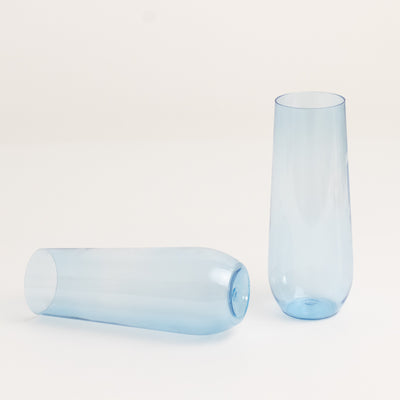 Two modern blue glass vases in a studio-style isolation shot.