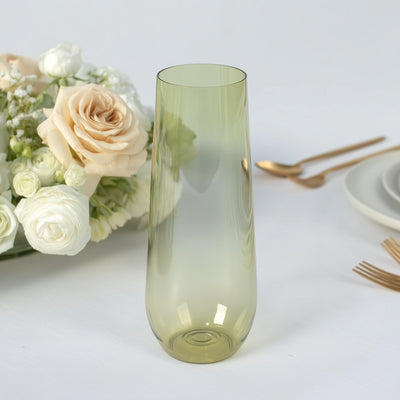 Green glass vase with elegant shape against a white background.