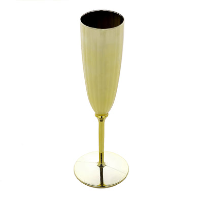 Gold champagne flute on a plain white background