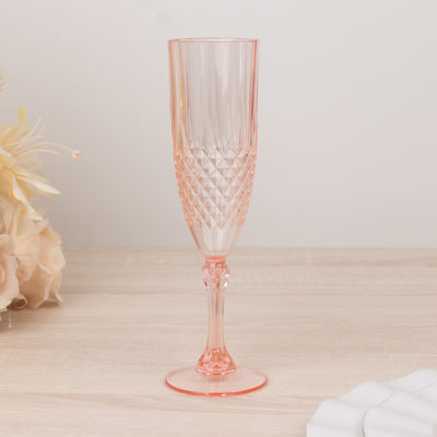 Pink crystal champagne flute with diamond pattern design.