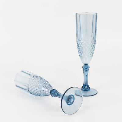 Blue crystal champagne flutes on a white background.