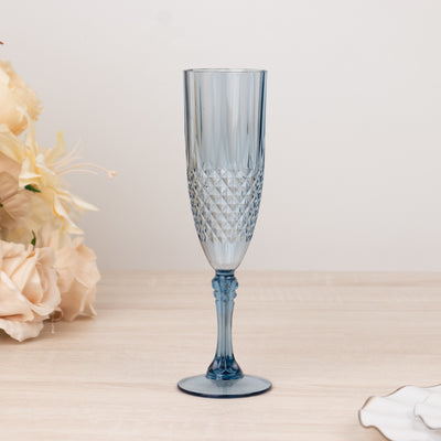 Blue crystal champagne flute on a plain background.