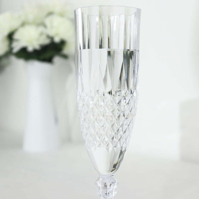 Cut crystal champagne flute with water, elegant design.