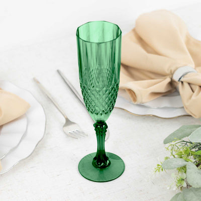 Green crystal champagne flute on a dining table setting.
