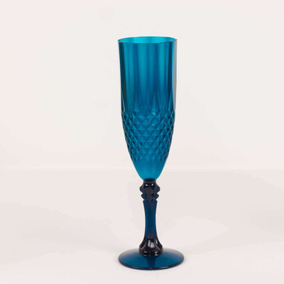 Blue crystal champagne flute with intricate diamond pattern.