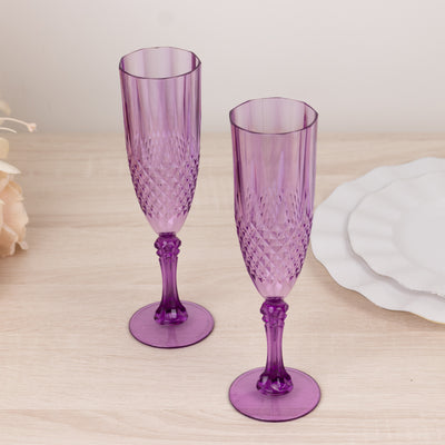 Purple decorative champagne flutes on a wooden surface.