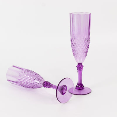Purple crystal champagne flutes on a white background