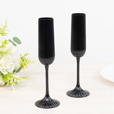 Black fluted champagne flutes with elegant stem and wide base