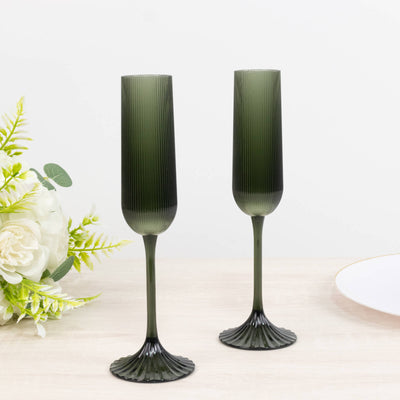 Green ribbed champagne flutes with fluted bases, elegant tableware set