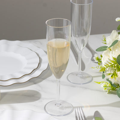 Elegant champagne flute with sparkling drink on a dining table setting.