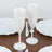 White plastic champagne flutes on a table with white plates