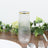 Elegant glass vase with ribbed texture and gold rim, perfect for floral arrangements.
