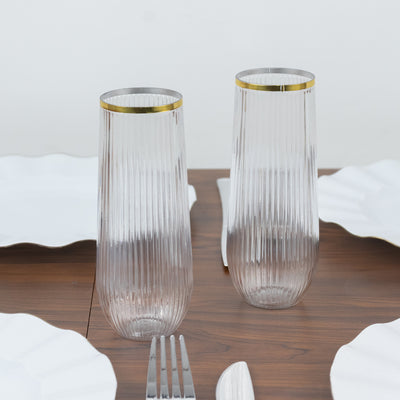 Elegant ribbed glassware with gold accents on a dining table.