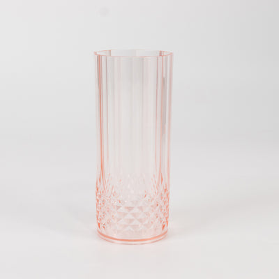 Pink crystal vase with geometric design on a white background