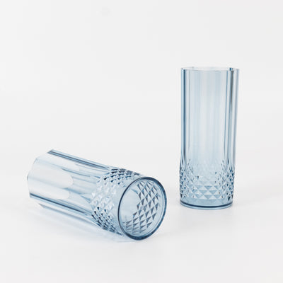 Blue crystal tumblers with geometric patterns on a white background.