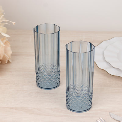 Set of two blue decorative glasses on a wooden table.