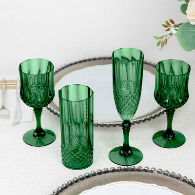 Set of elegant green glassware on a table with decorative plates.