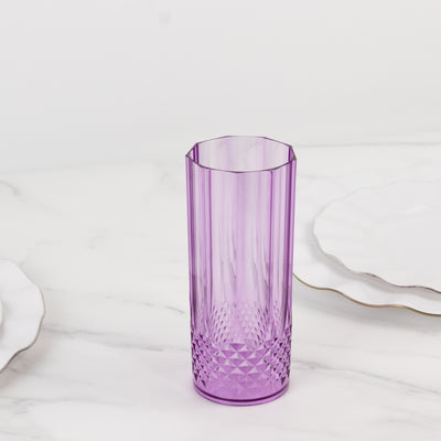 Purple textured glass tumbler on a marble surface.