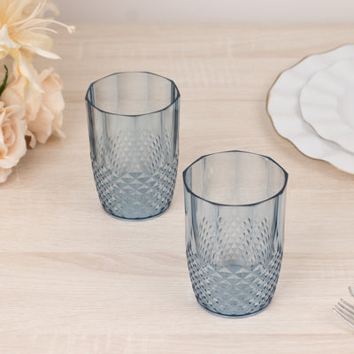 Blue patterned tumblers on a wooden table with floral decor.