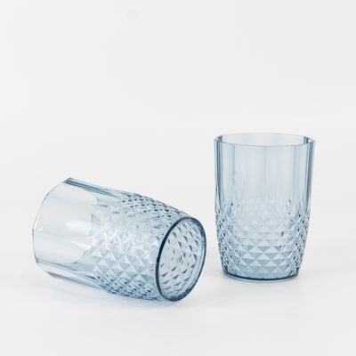 Two blue crystal tumblers on a white background.