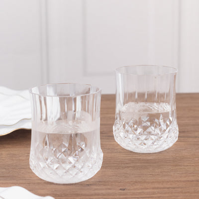 Set of two crystal glasses on a wooden table.