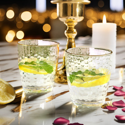 Elegant glass tumblers with lemon and mint on a beautifully set table.