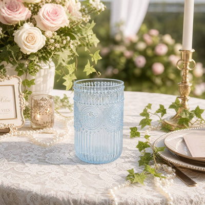 Blue glass votive candle holder on elegant floral wedding table decor