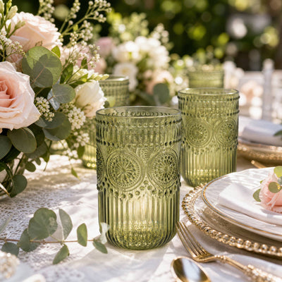 Elegant floral table setting with green glass votives and blush roses