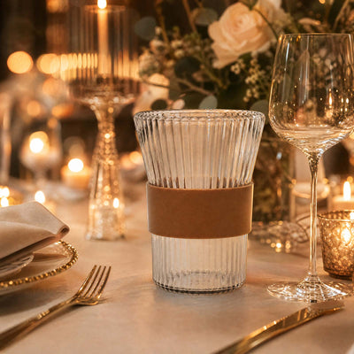 Elegant candlelit wedding table setting with crystal glassware and gold accents