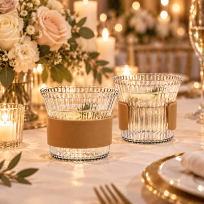 Elegant candlelit wedding table with crystal votives and floral centerpiece