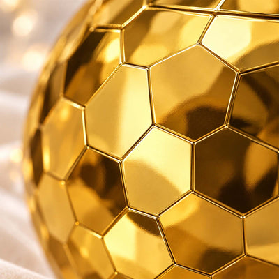 Close-up of glossy gold faceted hexagon mirror tiles on a disco ball cup