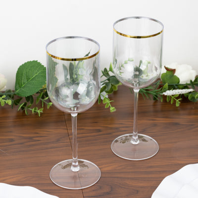 Elegant clear wine glasses with gold rim on wooden table.