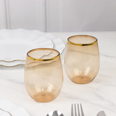 Amber glass tumblers on a marble table setting.