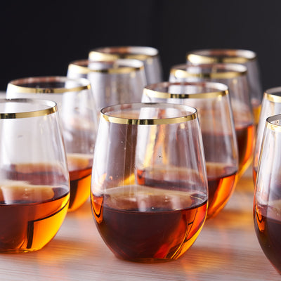 Elegant glassware with golden rims, filled with amber liquid.