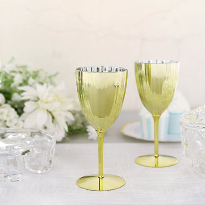 Gold decorative wine glasses on a table with floral accents.