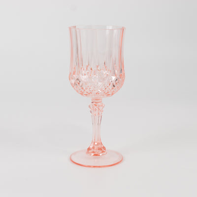 Pink crystal wine glass with intricate cut design