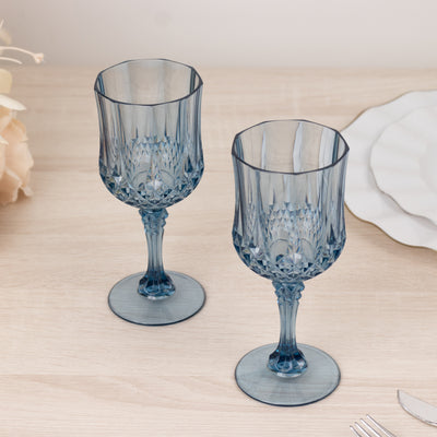 Blue crystal wine glasses on a wooden table.