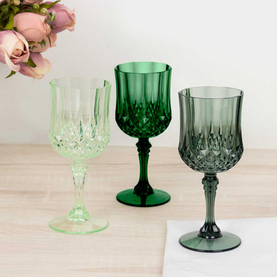 Set of three decorative crystal glasses in green and light green tones.