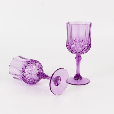 Purple crystal wine glasses on a white background.
