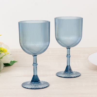 Blue ribbed wine glasses set on a wooden table.
