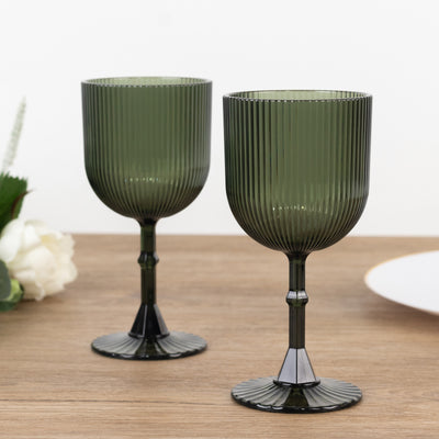 Green ribbed glassware on a wooden table.