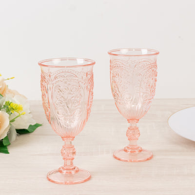 Elegant pink decorative glasses on a light wooden surface.
