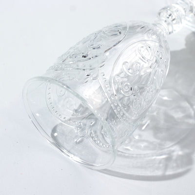 Elegant clear glass goblet with intricate embossed design
