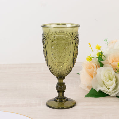 Green decorative goblet with intricate designs on a neutral background.