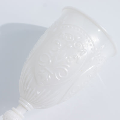 White decorative cup with intricate embossed design