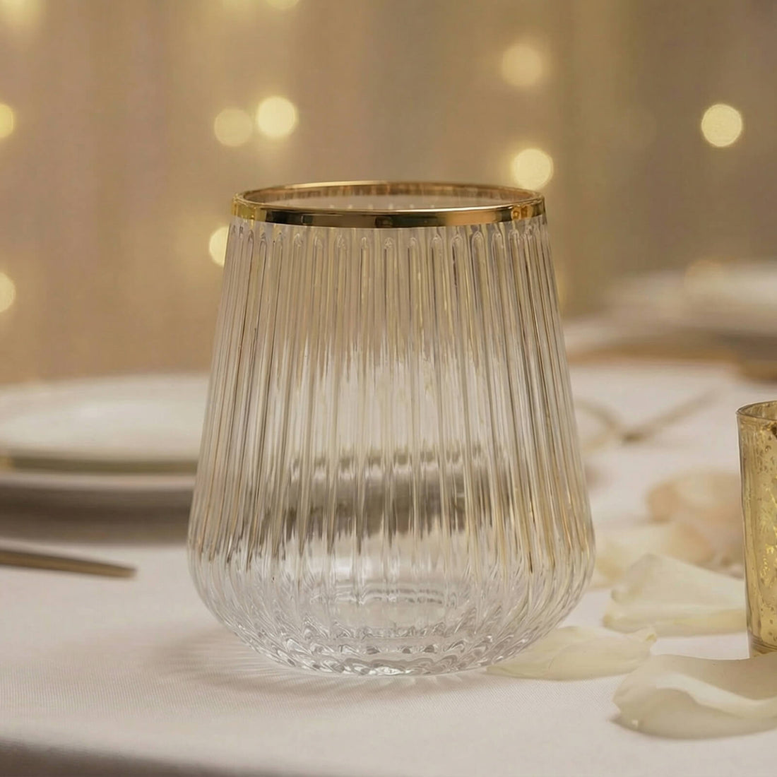 Gold-rimmed ribbed glass tumbler on elegant table setting